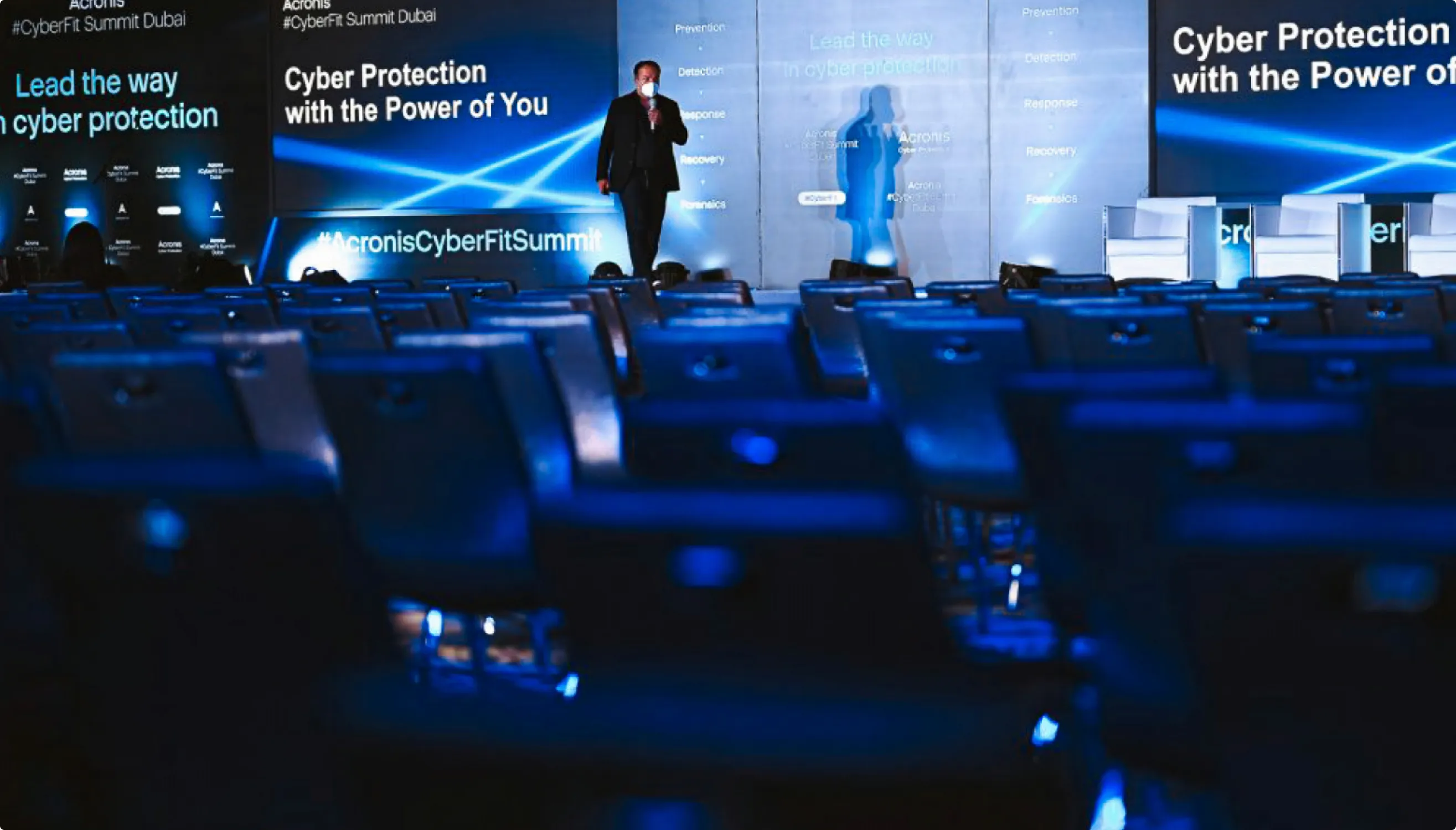 Acronis summit main stage with light-ray backdrop
