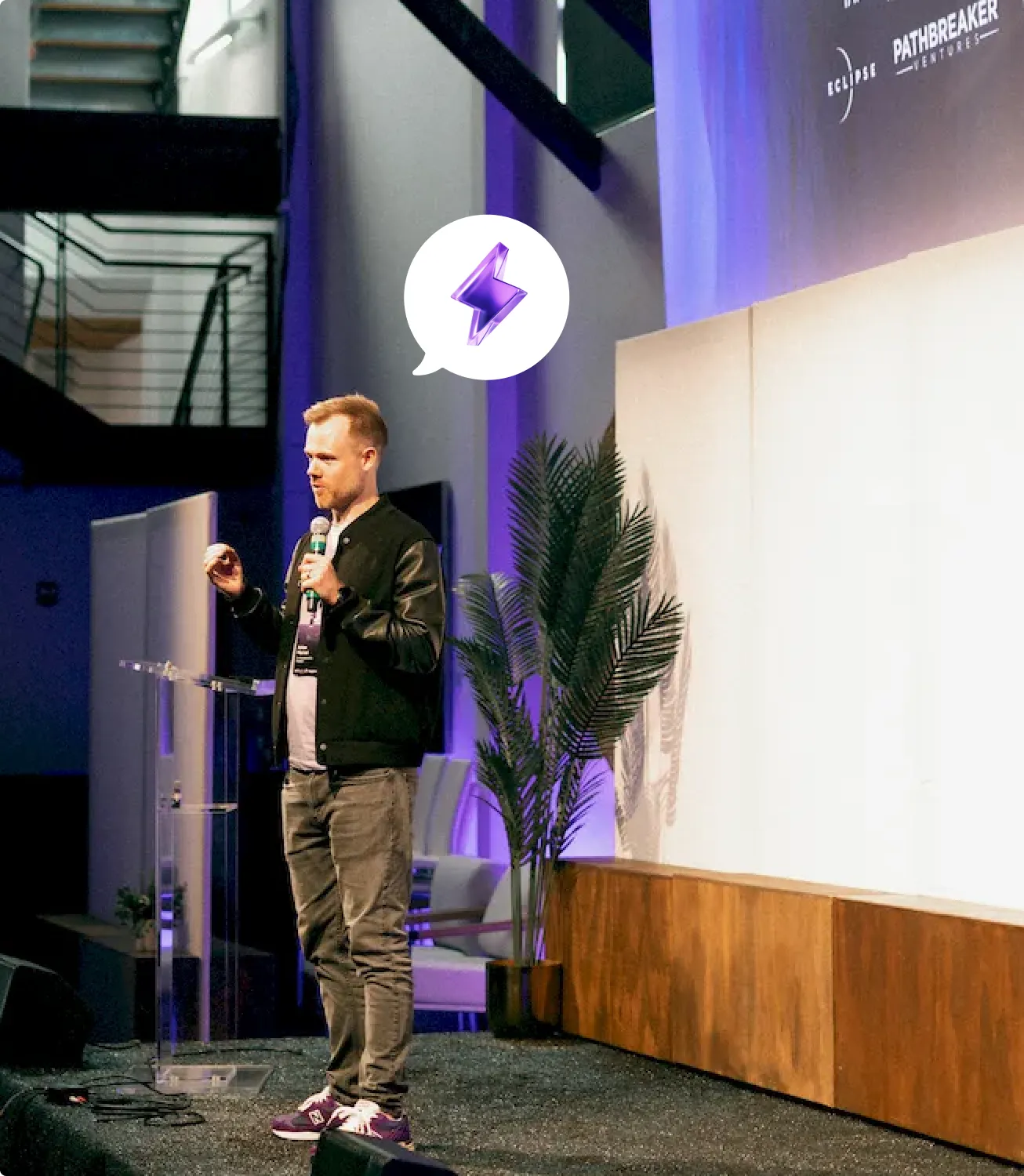 Photo of a speaker presenting on stage at the Actuate summit