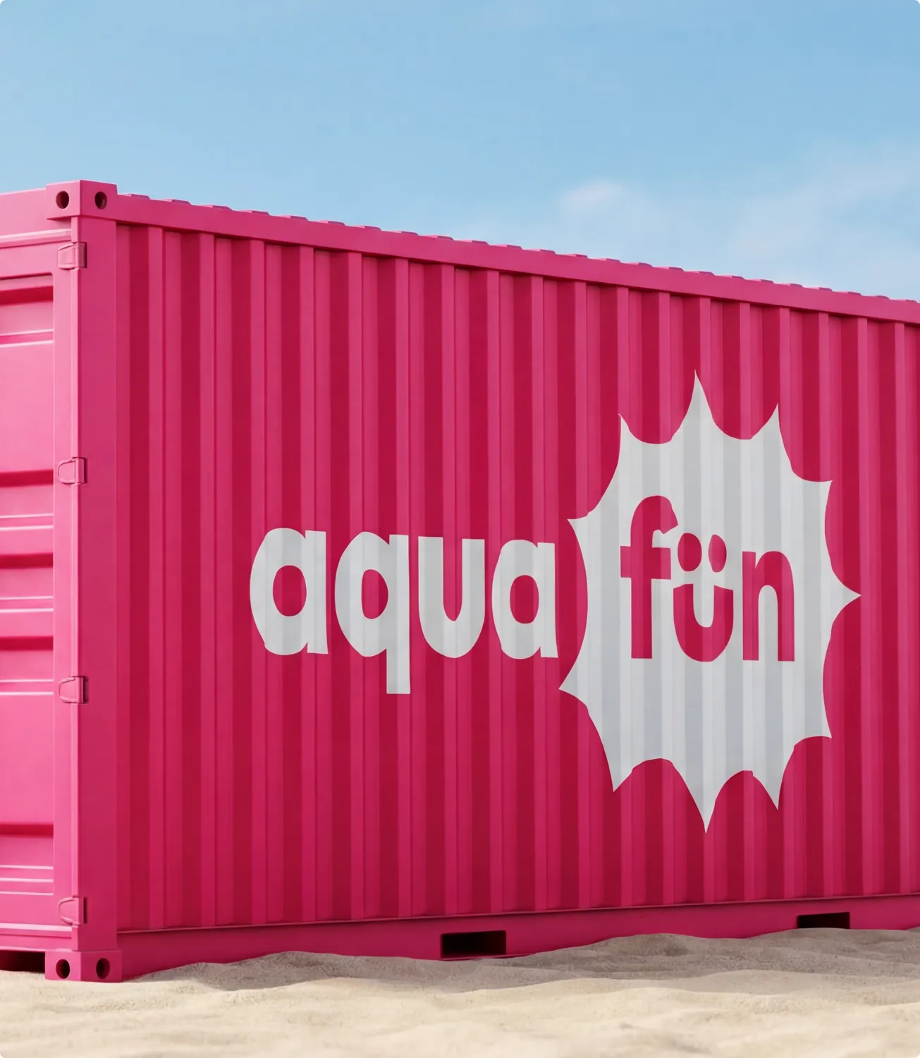 Bright pink shipping container standing on sand under a blue sky, painted with a large white aqua fun starburst logo