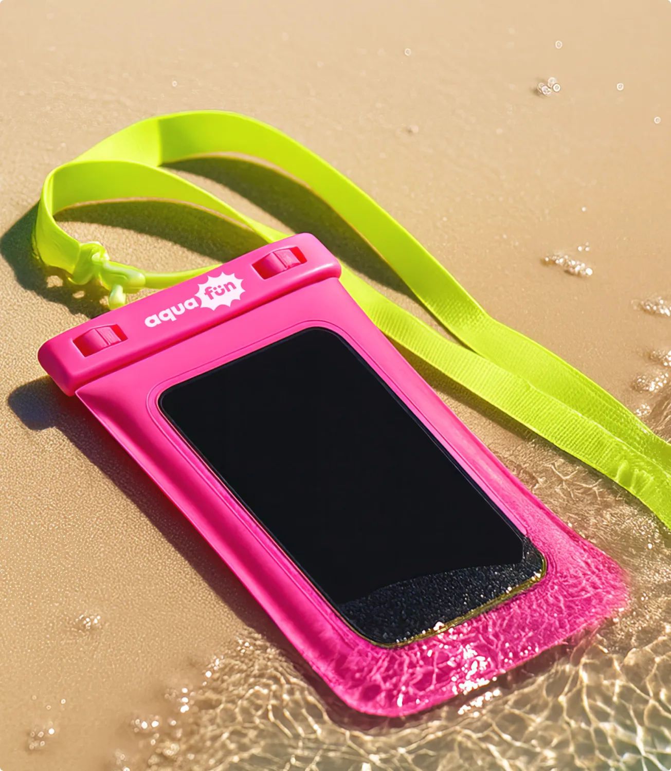 Bright pink aqua fun waterproof phone pouch with a lime-green lanyard, lying on wet sand at the water’s edge