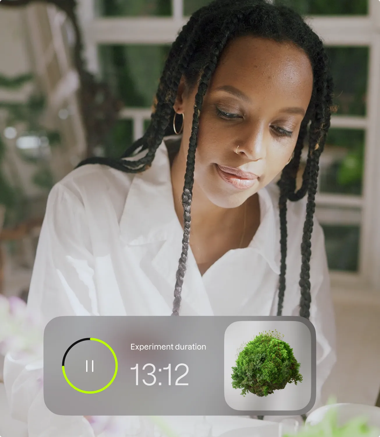 A scientist in a white coat in a bright lab with a floating Bow app card showing an experiment duration timer of 13:12