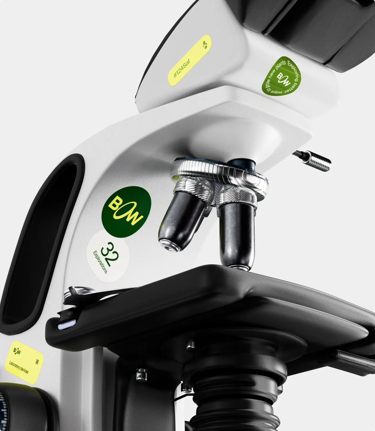 A white laboratory microscope decorated with Bow logo and caption stickers