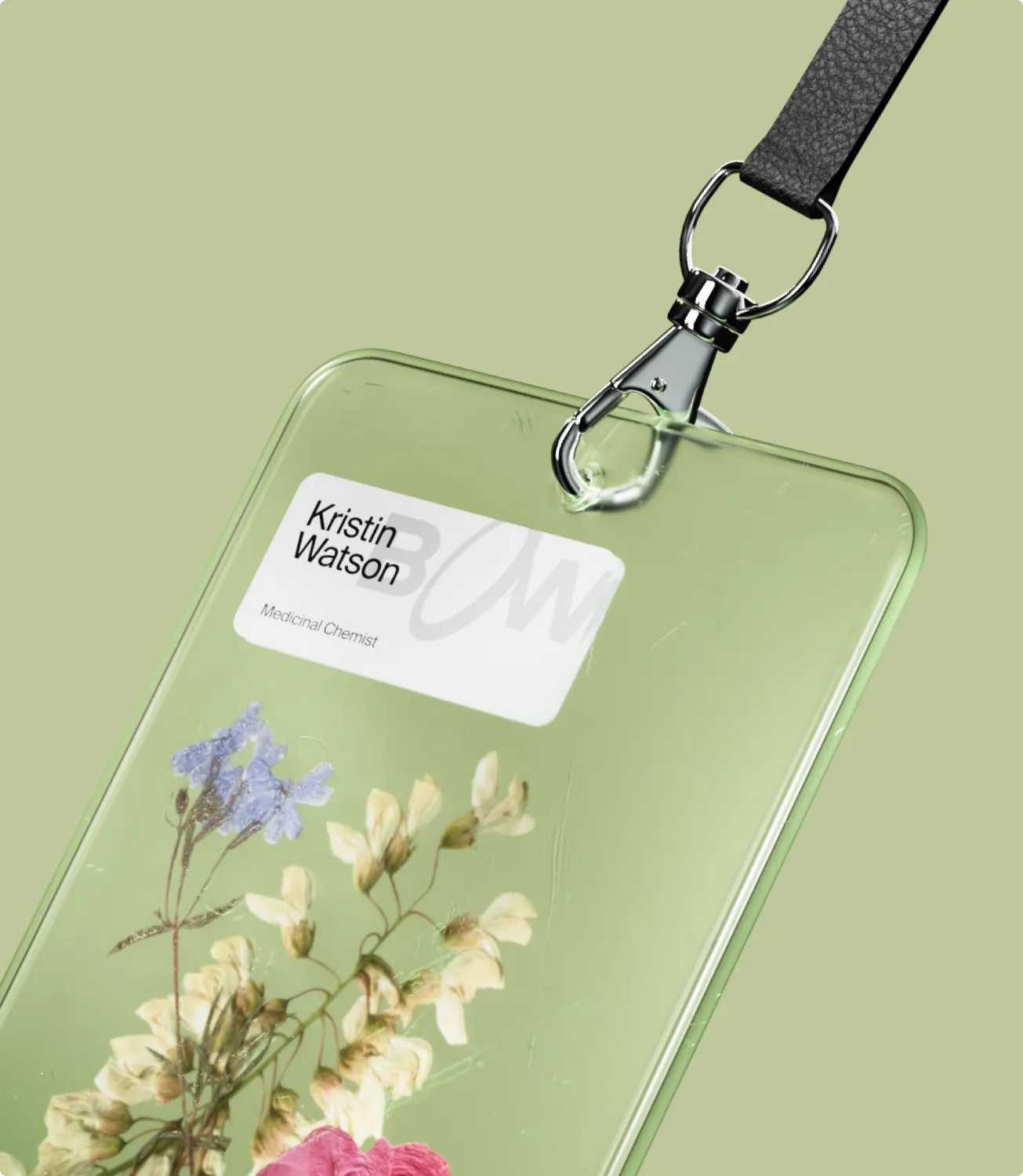 A Bow staff lanyard badge for Kristin Watson, Medicinal Chemist, with pressed botanicals under the surface