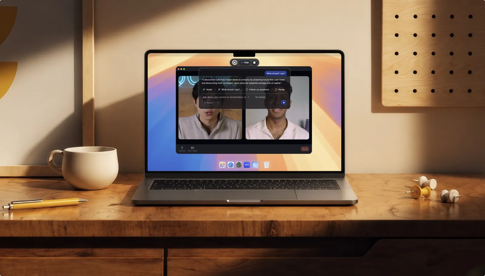 A laptop on a wooden desk running a Cluely video call