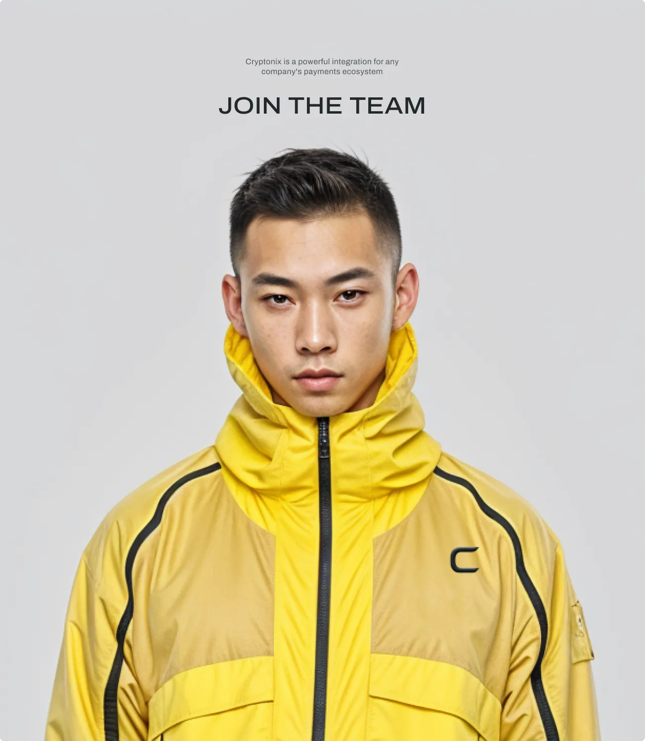 Man wearing a yellow Cryptonix branded jacket — join the team