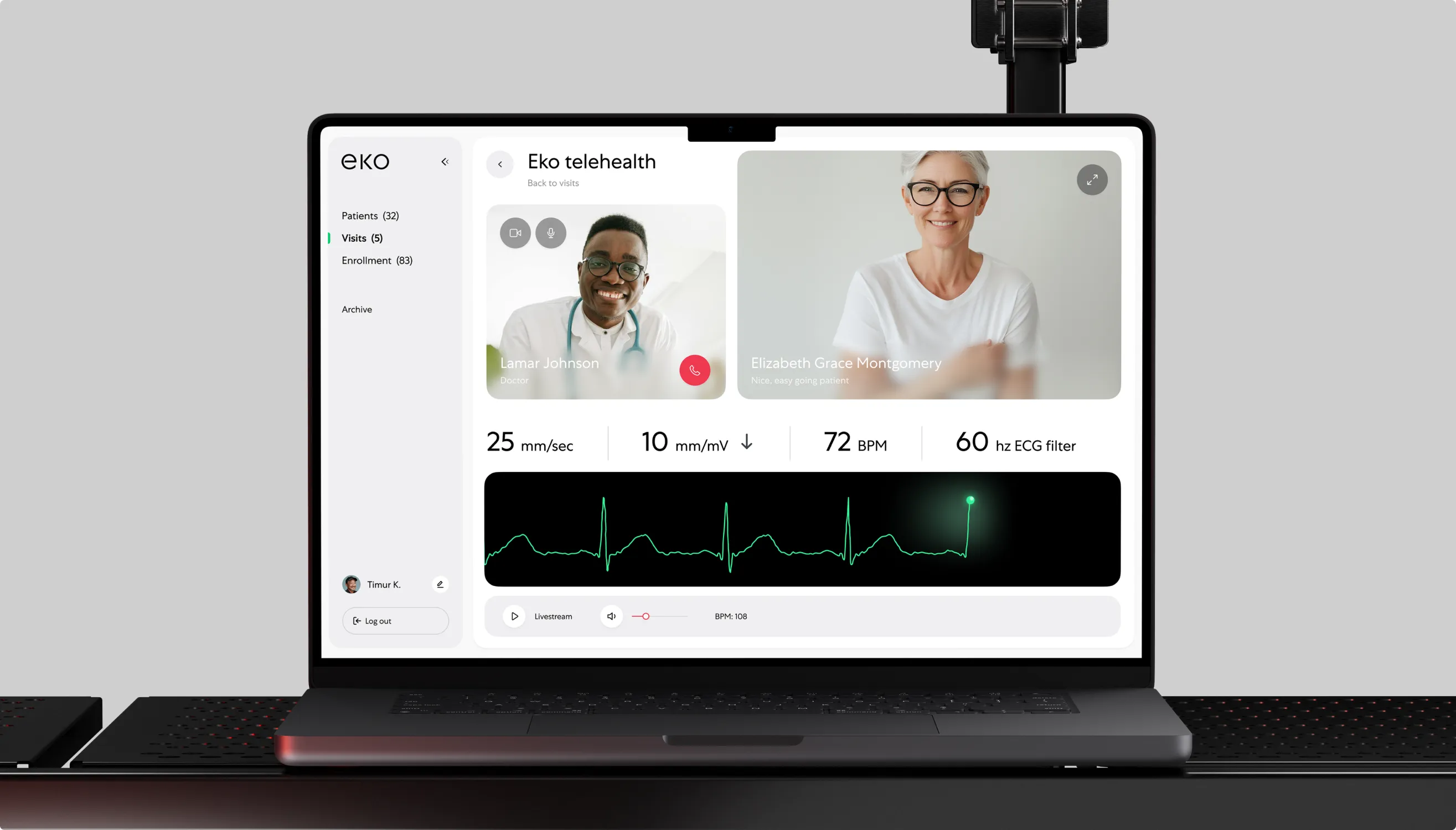 Laptop showing the Eko telehealth video-call dashboard with two participants and a live green ECG waveform