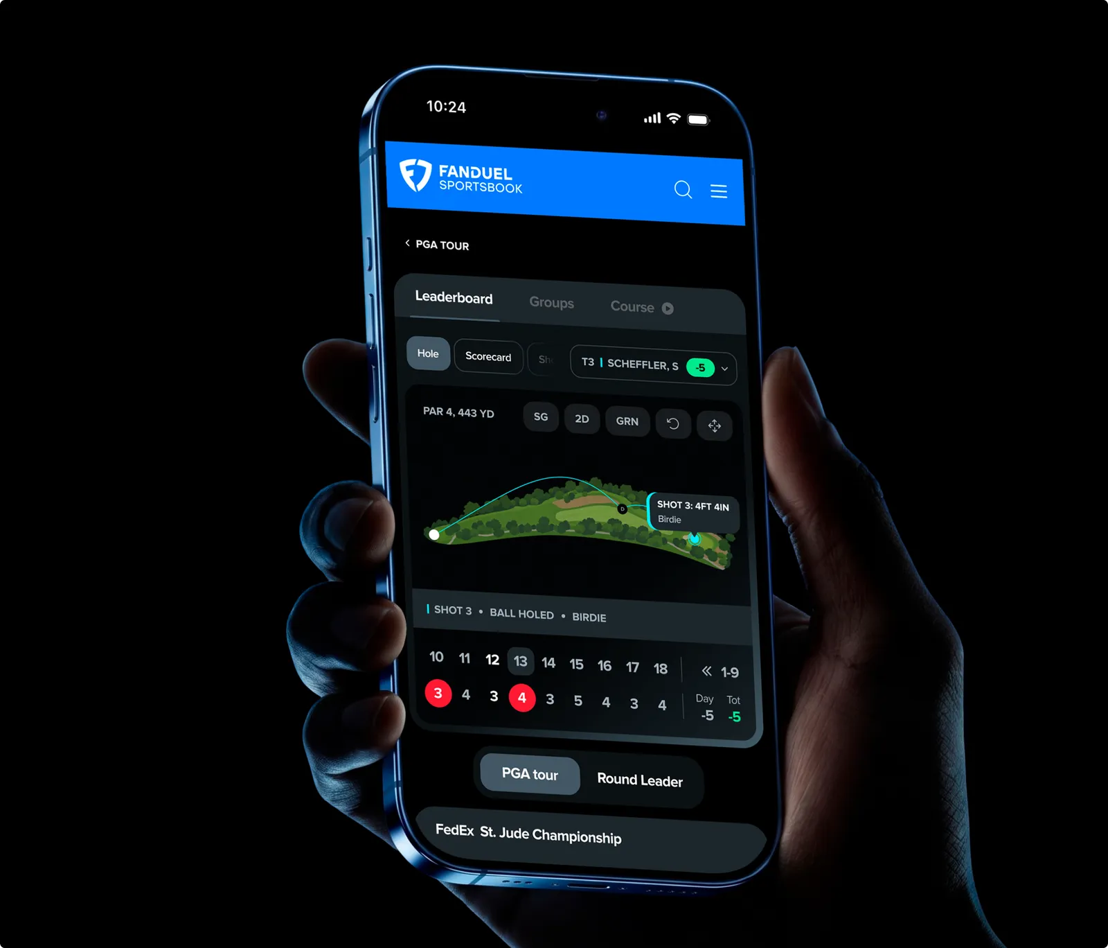 A hand holding a phone with the FanDuel Sportsbook golf leaderboard open on a PGA Tour round