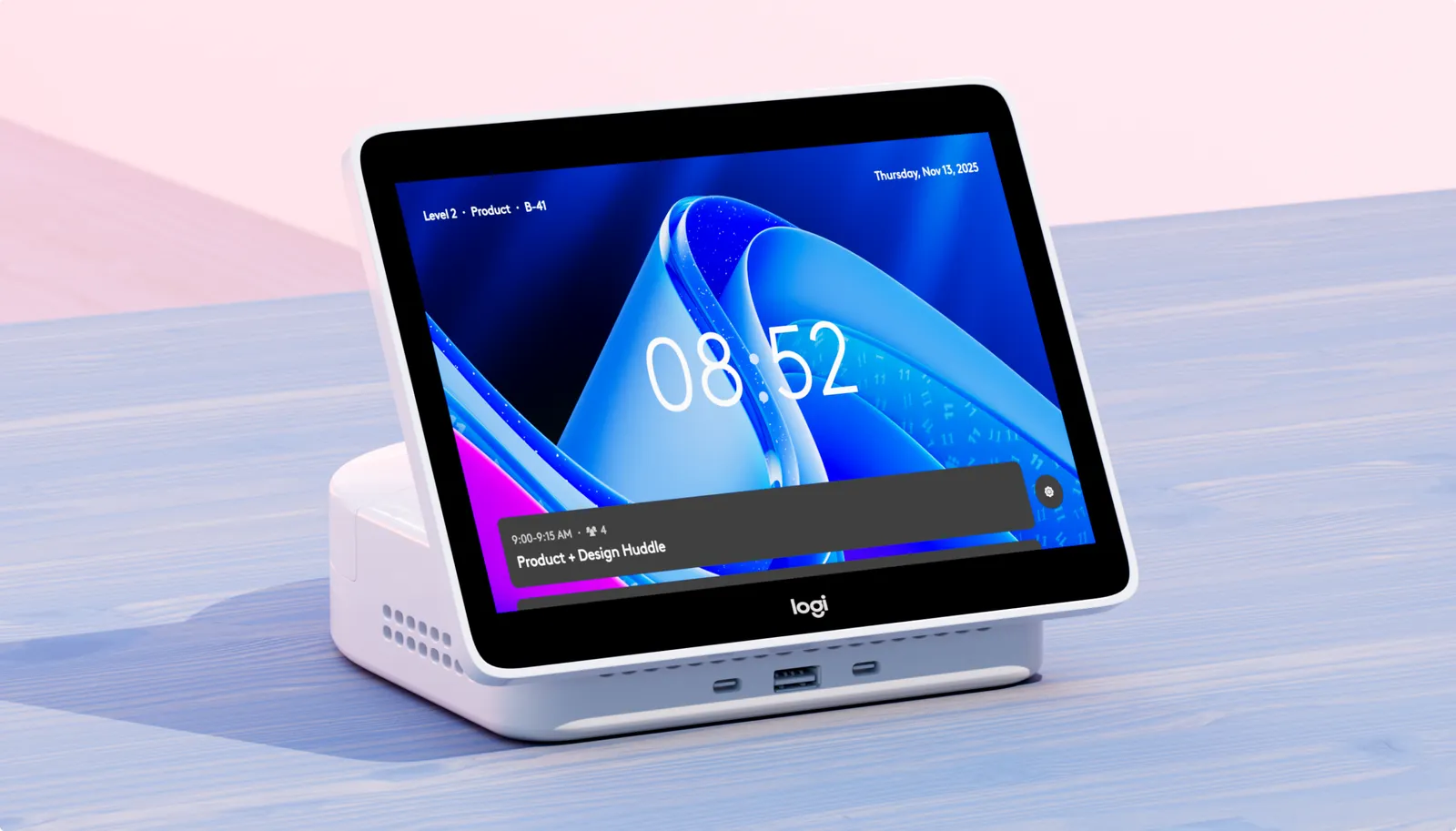 Logi Dock Flex on a desk, its screen showing the time and the next meeting of the day