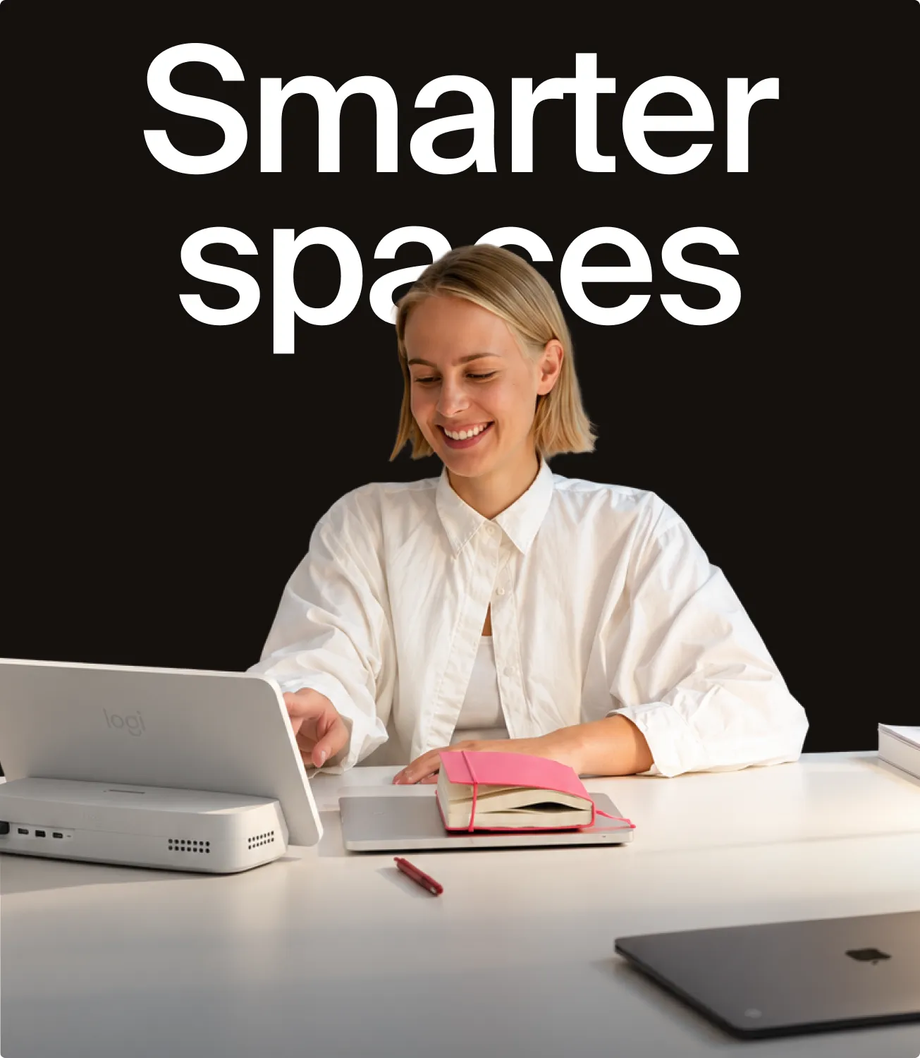 Smarter spaces — a person working at a desk with a Logi Dock Flex beside the laptop