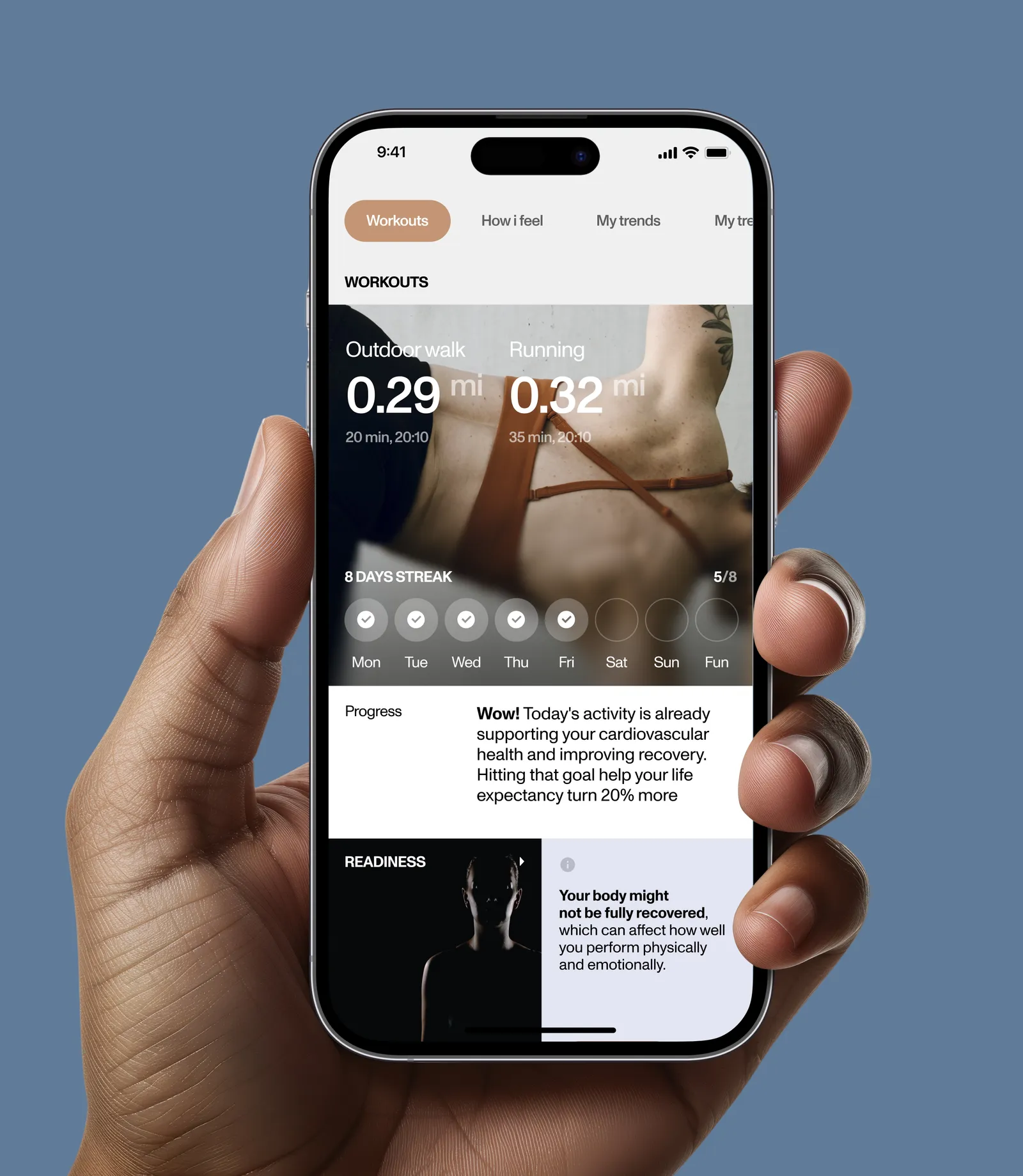 Hand holding a phone with the Luna workouts and progress screen