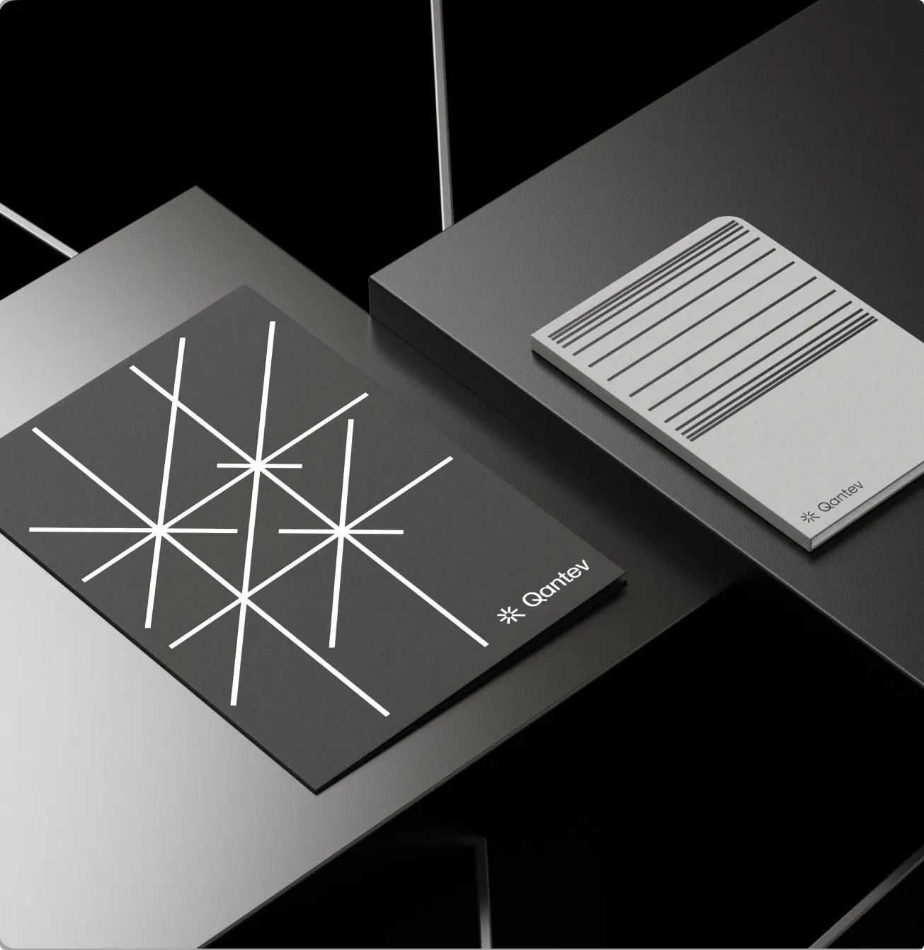 Two Qantev notebooks printed with the asterisk ray pattern
