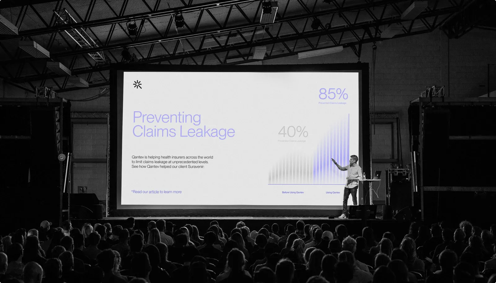 Qantev keynote on stage presenting Preventing Claims Leakage with 85% and 40% stats to a full auditorium