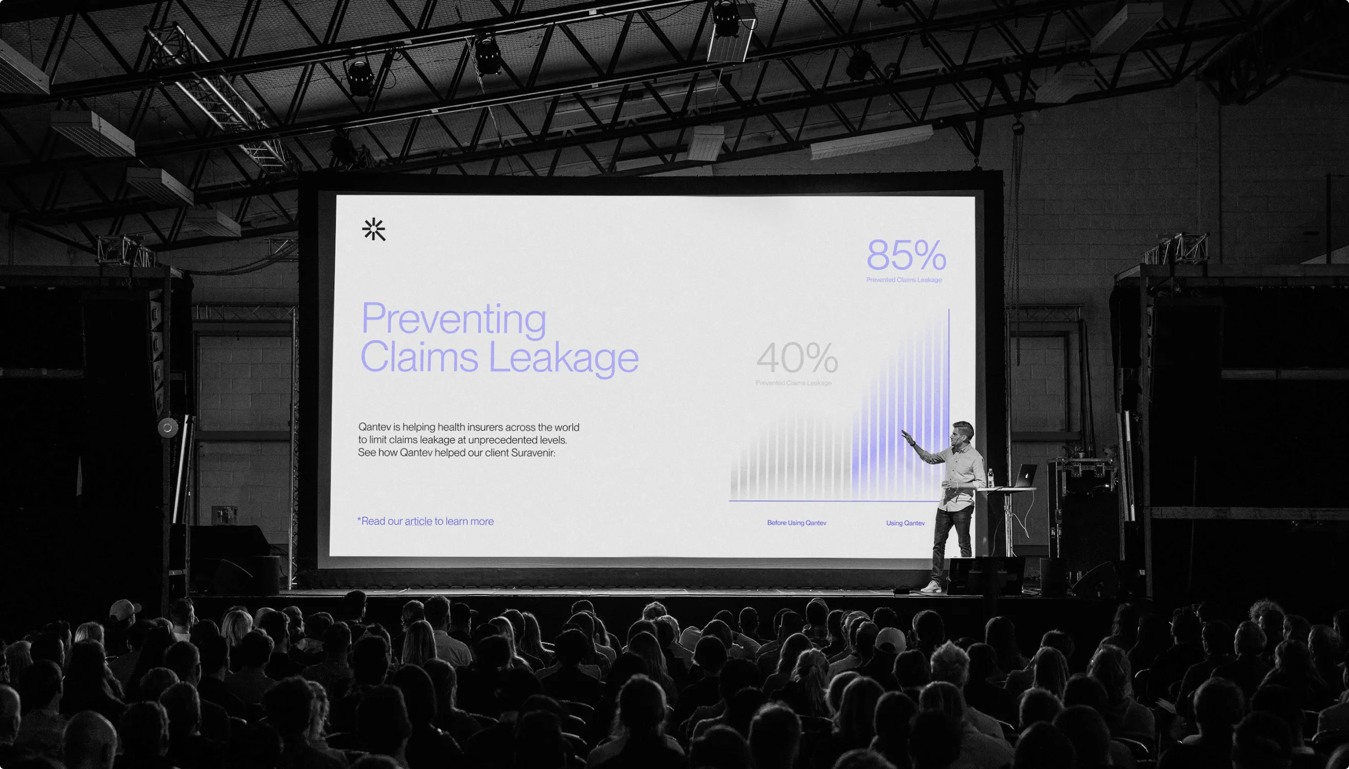 Qantev keynote on stage presenting Preventing Claims Leakage with 85% and 40% stats to a full auditorium