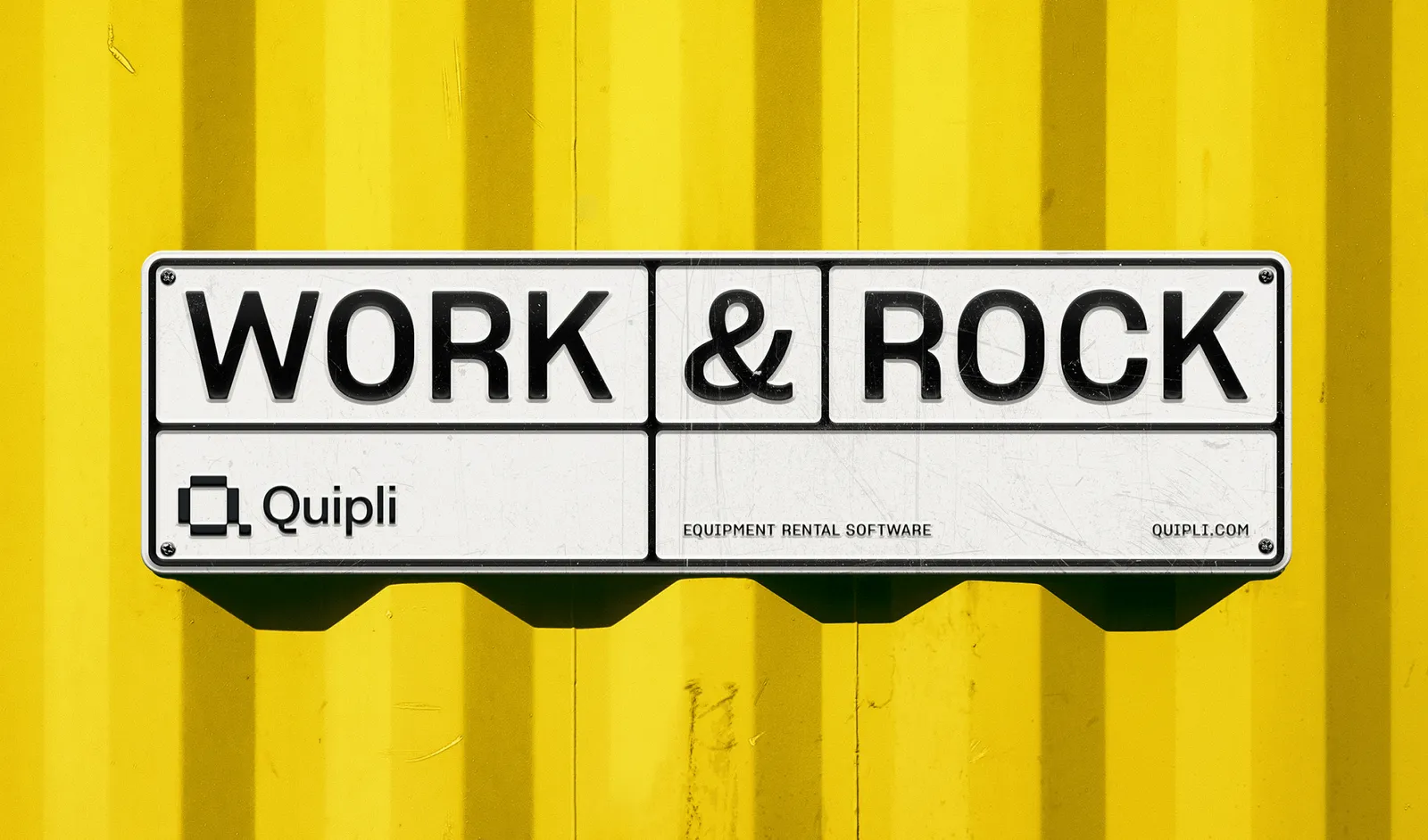 Enamel WORK & ROCK sign with the Quipli equipment rental software mark mounted on a yellow shipping container