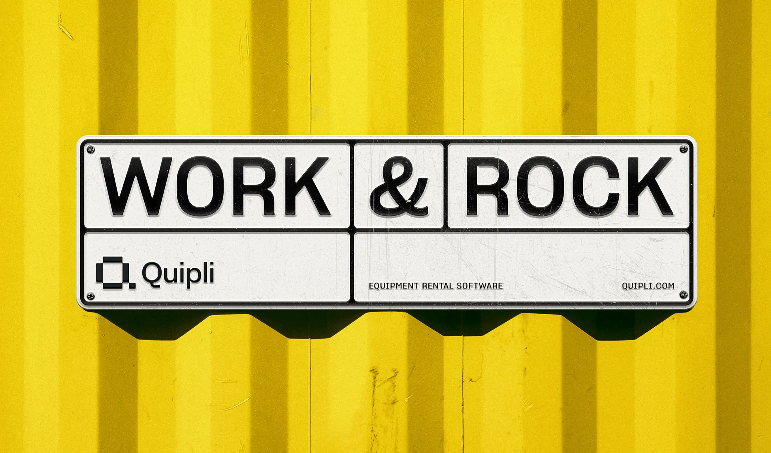 Enamel WORK & ROCK sign with the Quipli equipment rental software mark mounted on a yellow shipping container