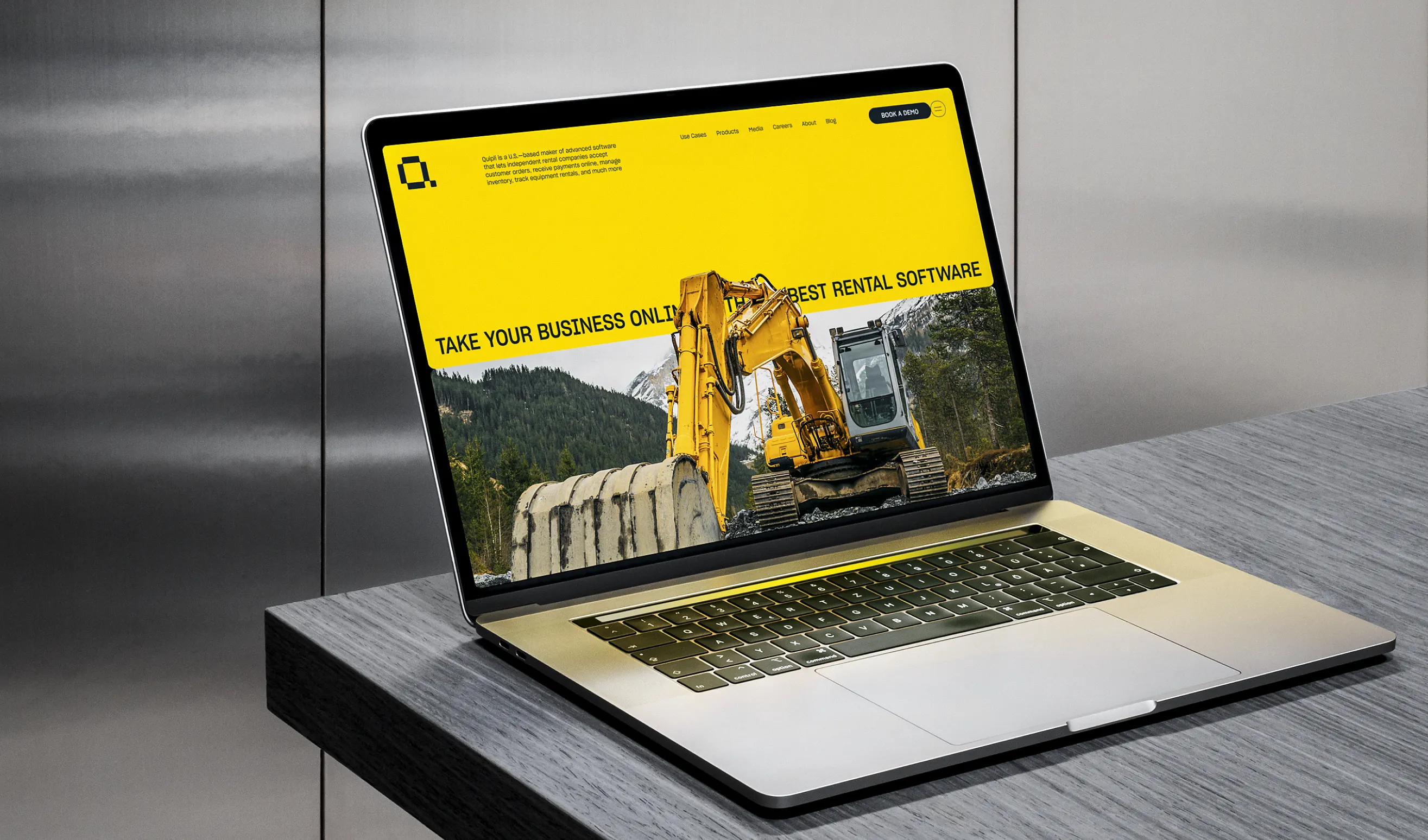 Laptop on a counter showing the Quipli website hero with an excavator and the headline Take your business online with the best rental software