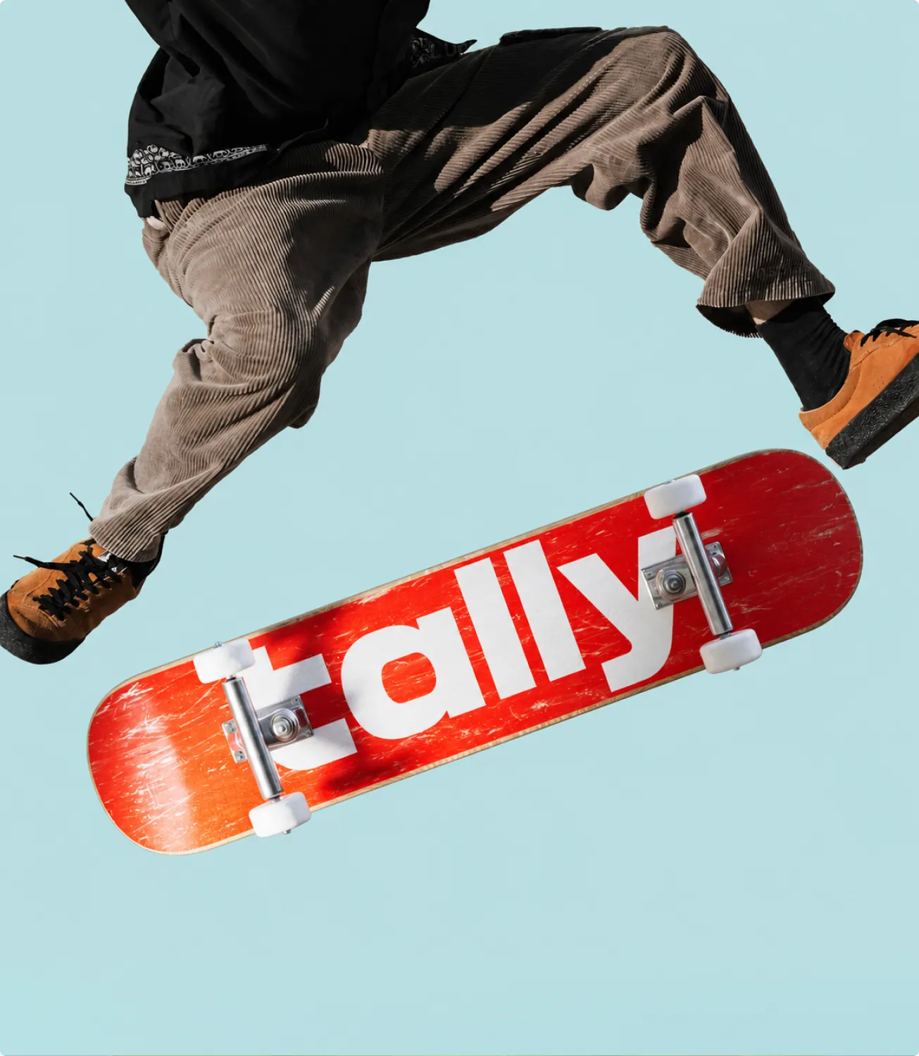 Red skateboard with the Tally logo mid-trick