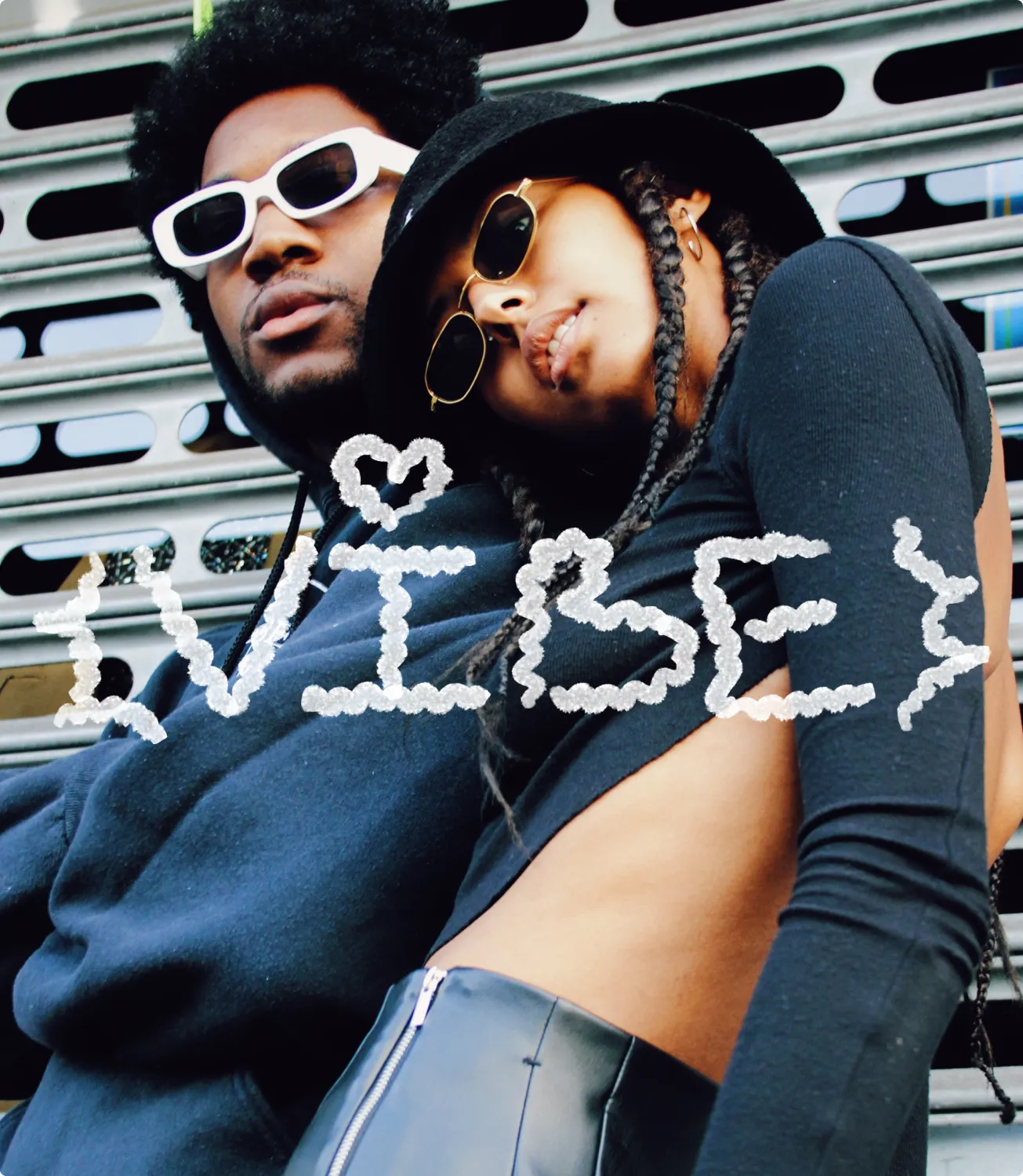 Black couple in sunglasses embracing outdoors with hand-drawn VIBE lettering